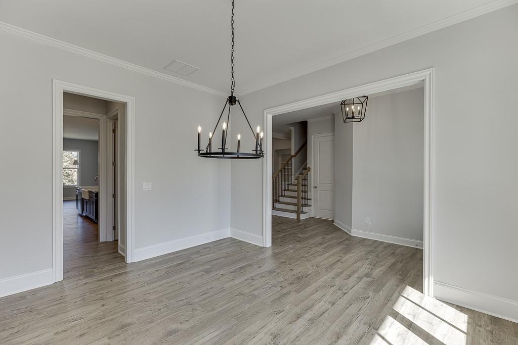 446 Thunder Road Buford, GA 30518 - Photo 6 of 79 a view of empty room with wooden floor