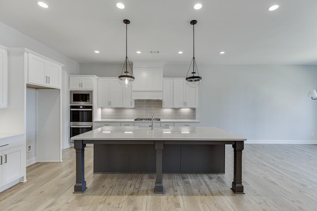 446 Thunder Road Buford, GA 30518 - Photo 10 of 79 a kitchen with kitchen island a sink stainless steel appliances and cabinets