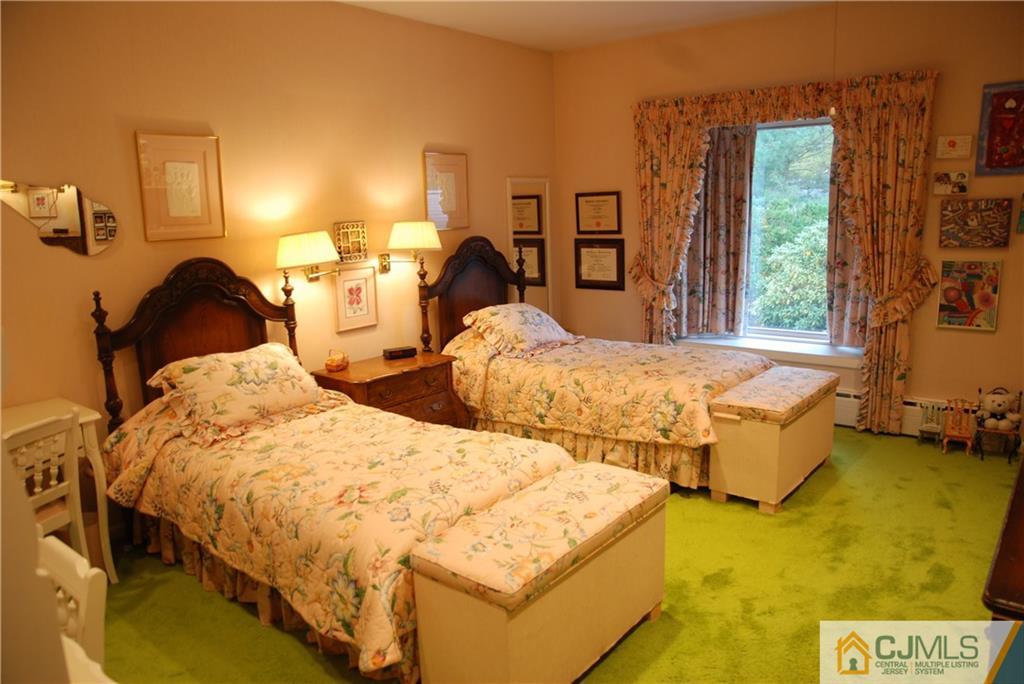 5 Moraine Road Edison, NJ 08820 - Photo 14 of 25 a bedroom with two beds and a dresser with the shoe rack