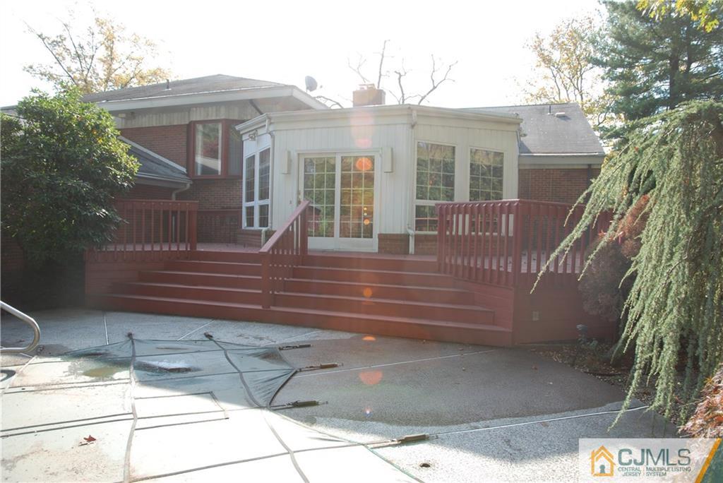 5 Moraine Road Edison, NJ 08820 - Photo 22 of 25 a view of a house with a small yard and large tree and wooden fence