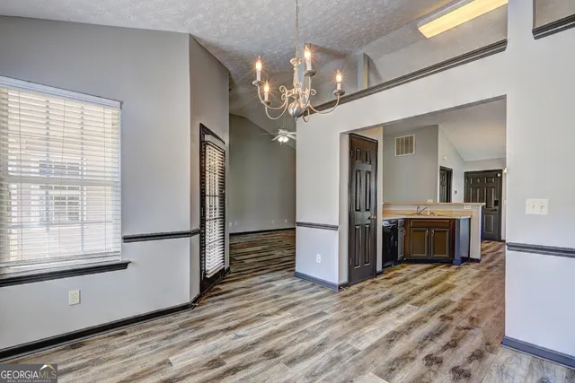 a view of a kitchen with a sink a refrigerator and a stove top oven
