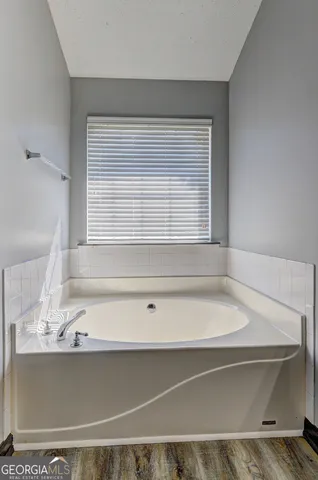 a bathroom with washing machine and window