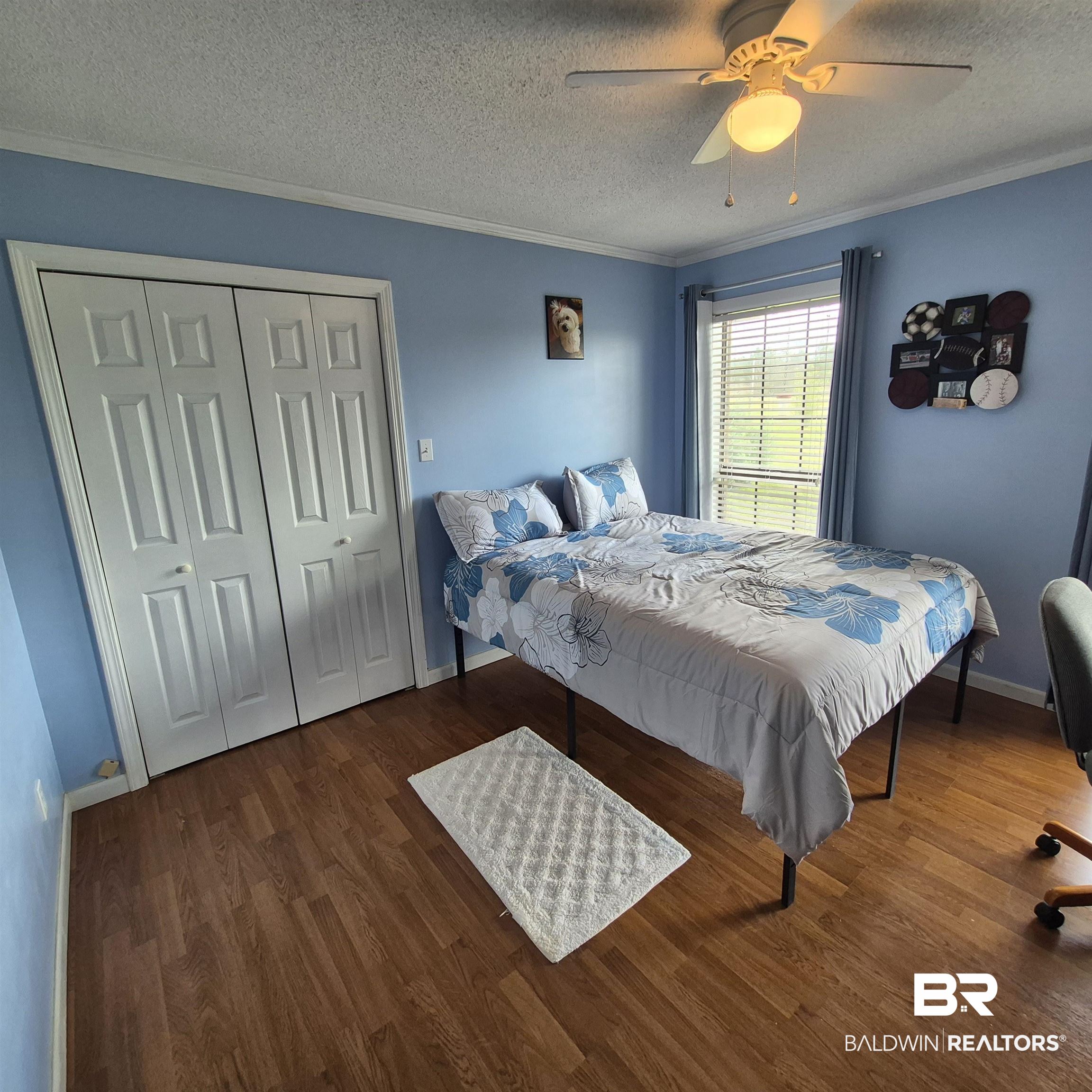 26635 Highway 41 Range, AL 36473 - Photo 27 of 74 Bedroom with a closet, a textured ceiling, dark wood-type flooring, a ceiling fan, and ornamental molding