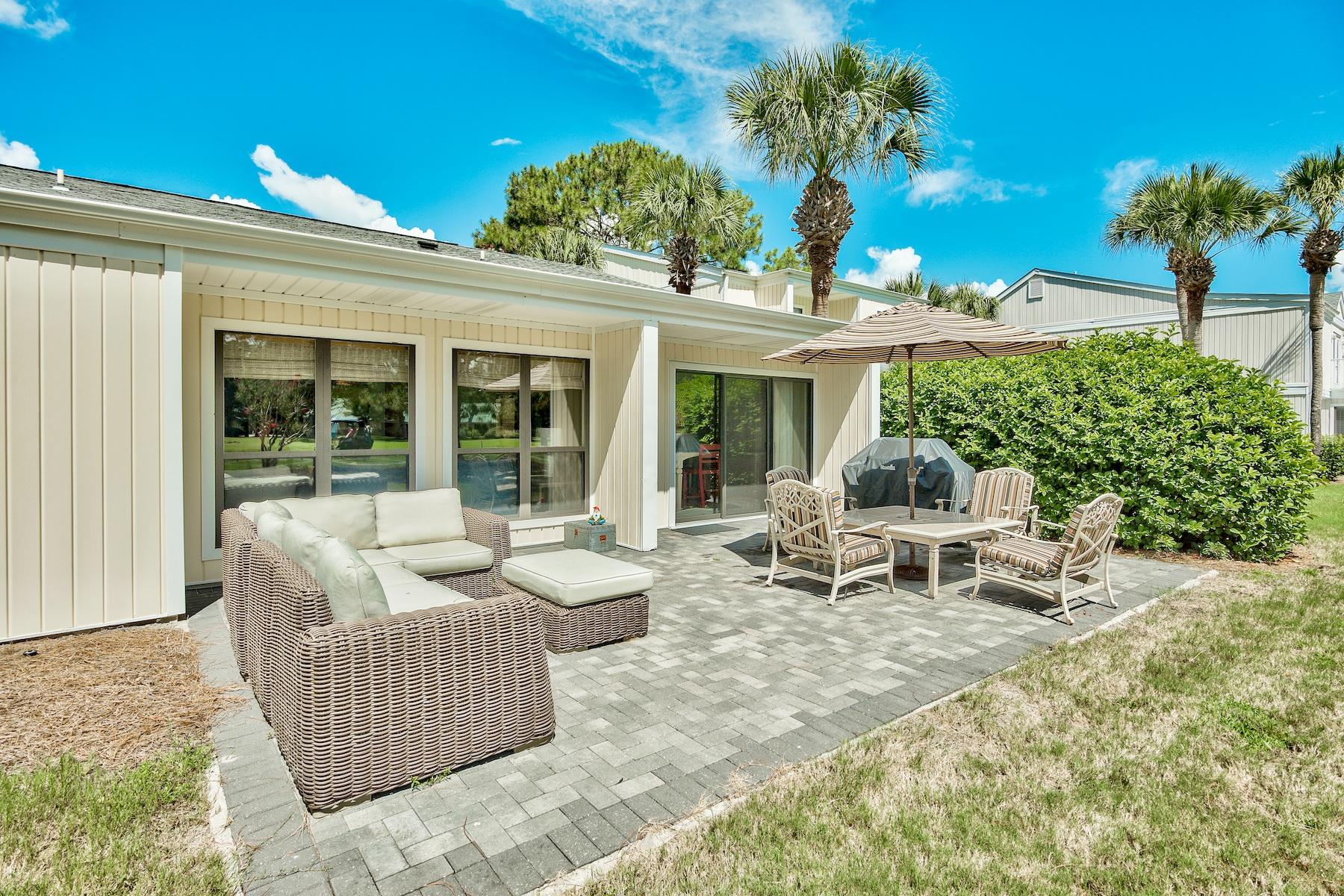 716 Sandpiper Drive, Unit 10508 Miramar Beach, FL 32550 - Photo 1 of 22 a view of a patio with couches and potted plants