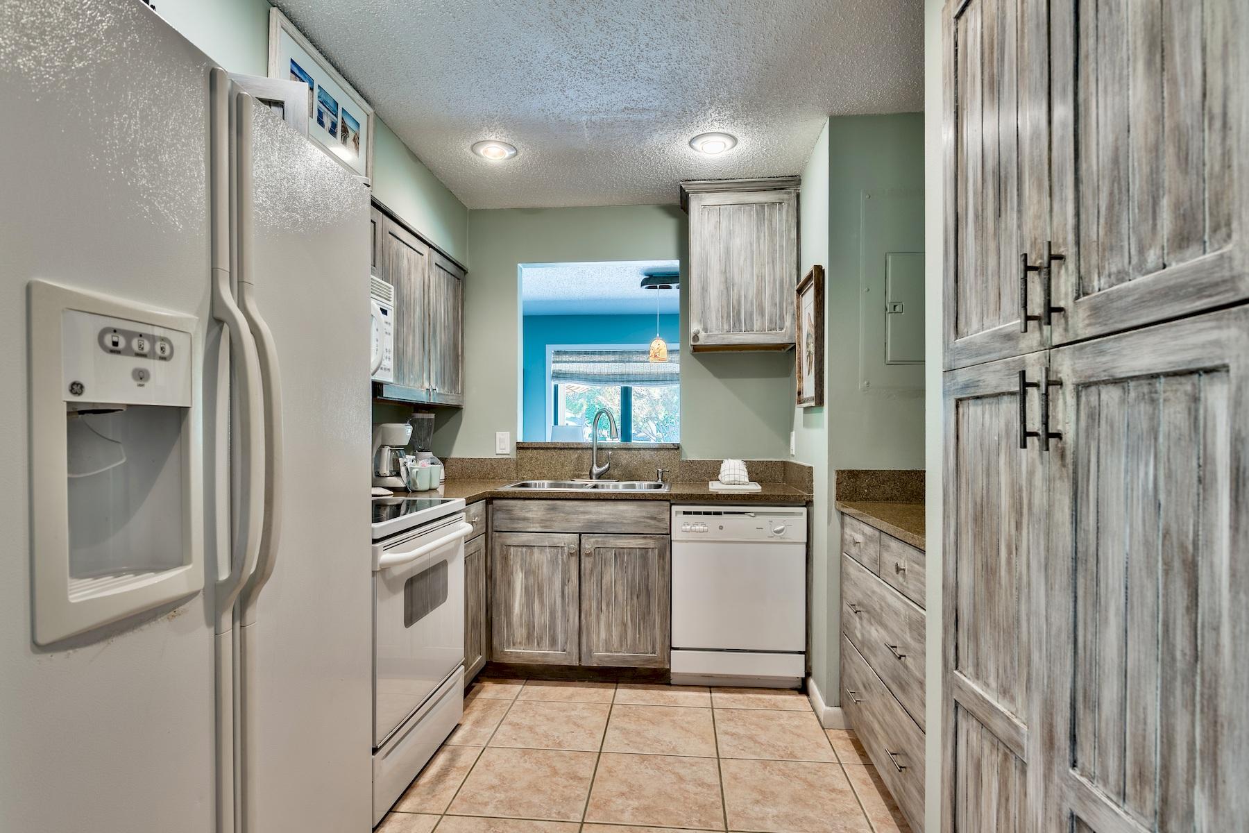 716 Sandpiper Drive, Unit 10508 Miramar Beach, FL 32550 - Photo 13 of 22 a kitchen with stainless steel appliances granite countertop a refrigerator and a stove
