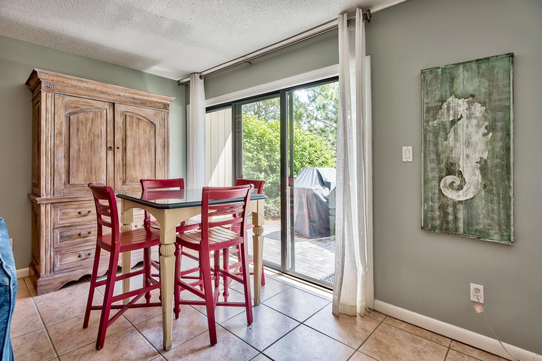716 Sandpiper Drive, Unit 10508 Miramar Beach, FL 32550 - Photo 17 of 22 a view of a dining room with furniture and a window