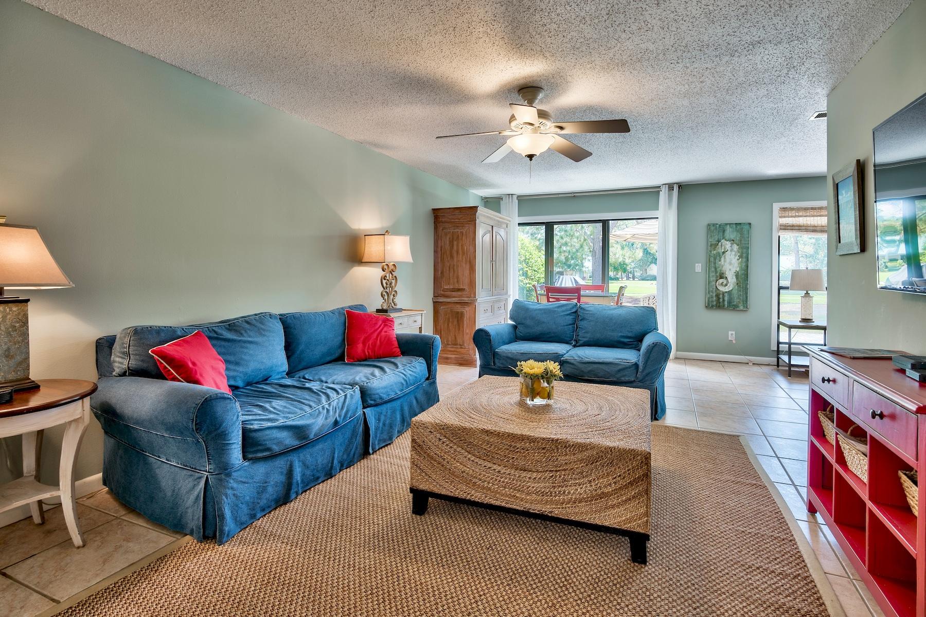 716 Sandpiper Drive, Unit 10508 Miramar Beach, FL 32550 - Photo 4 of 22 a living room with furniture and a chandelier