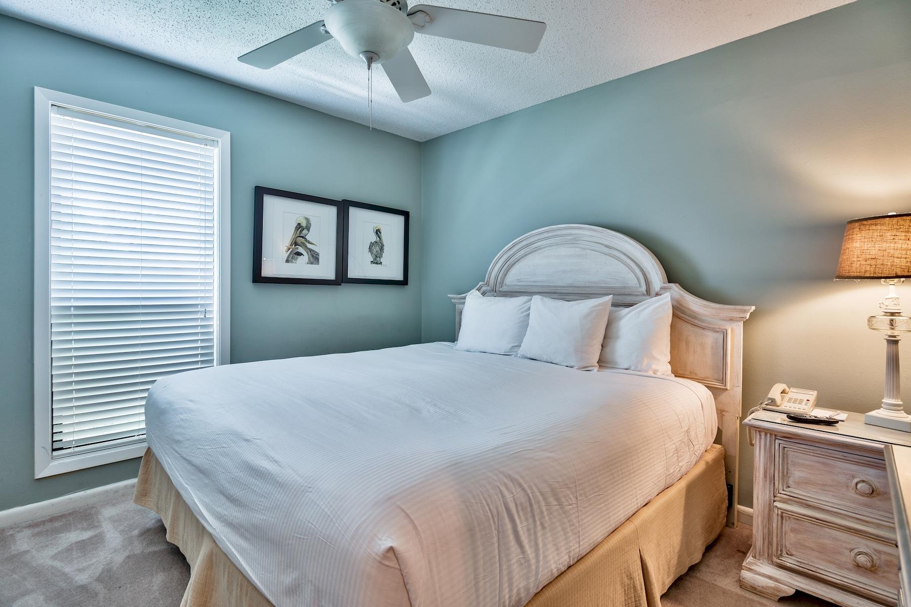 716 Sandpiper Drive, Unit 10508 Miramar Beach, FL 32550 - Photo 10 of 22 a bedroom with a large bed and a chandelier