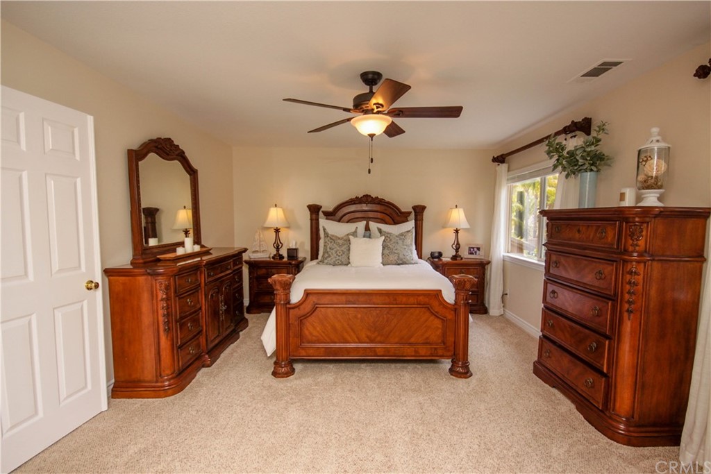 1836 Willow Bluff Drive Corona, CA 92883 - Photo 19 of 64 a bedroom with a bed and cabinets