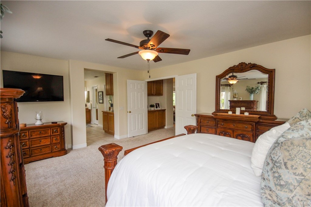 1836 Willow Bluff Drive Corona, CA 92883 - Photo 20 of 64 a bedroom with a bed and a flat screen tv