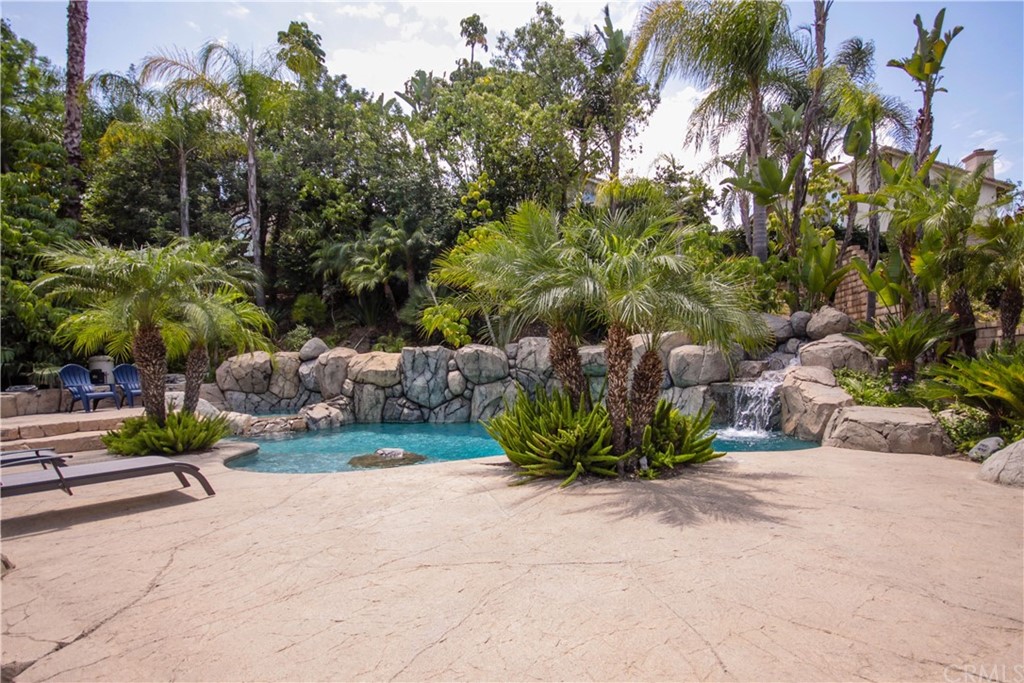 1836 Willow Bluff Drive Corona, CA 92883 - Photo 2 of 64 a view of a garden with a bench and some trees
