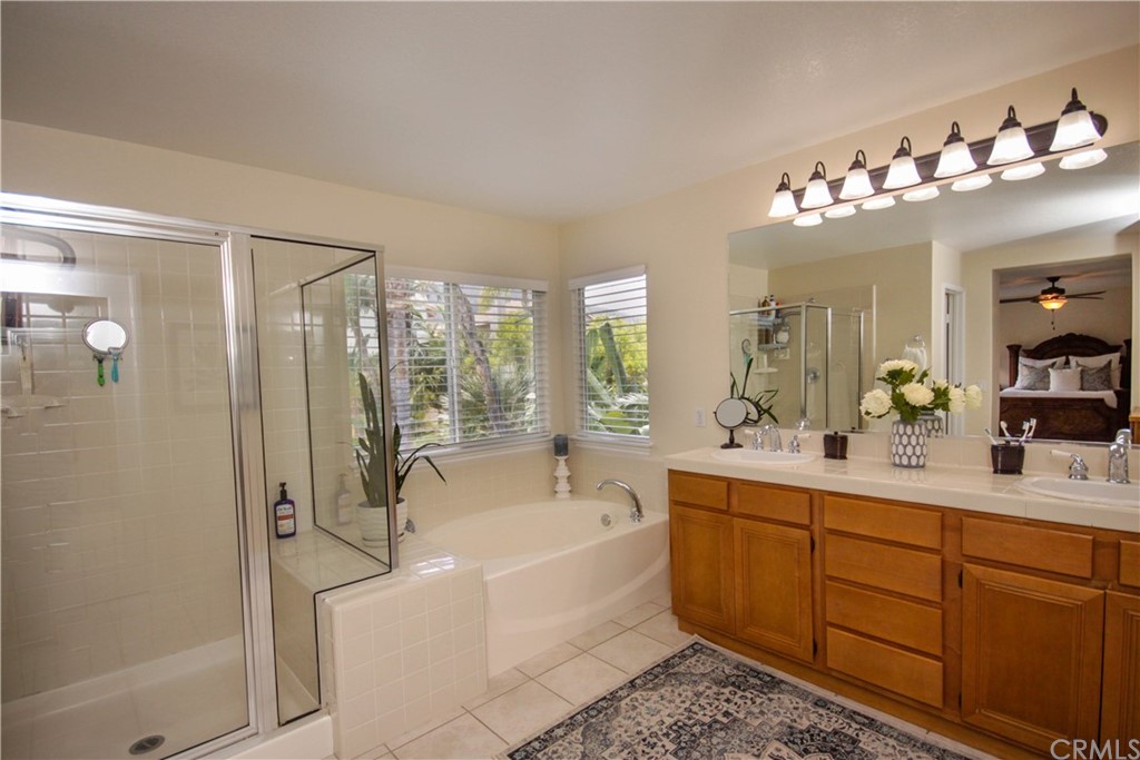 1836 Willow Bluff Drive Corona, CA 92883 - Photo 22 of 64 a bathroom with a tub sink shower and mirror