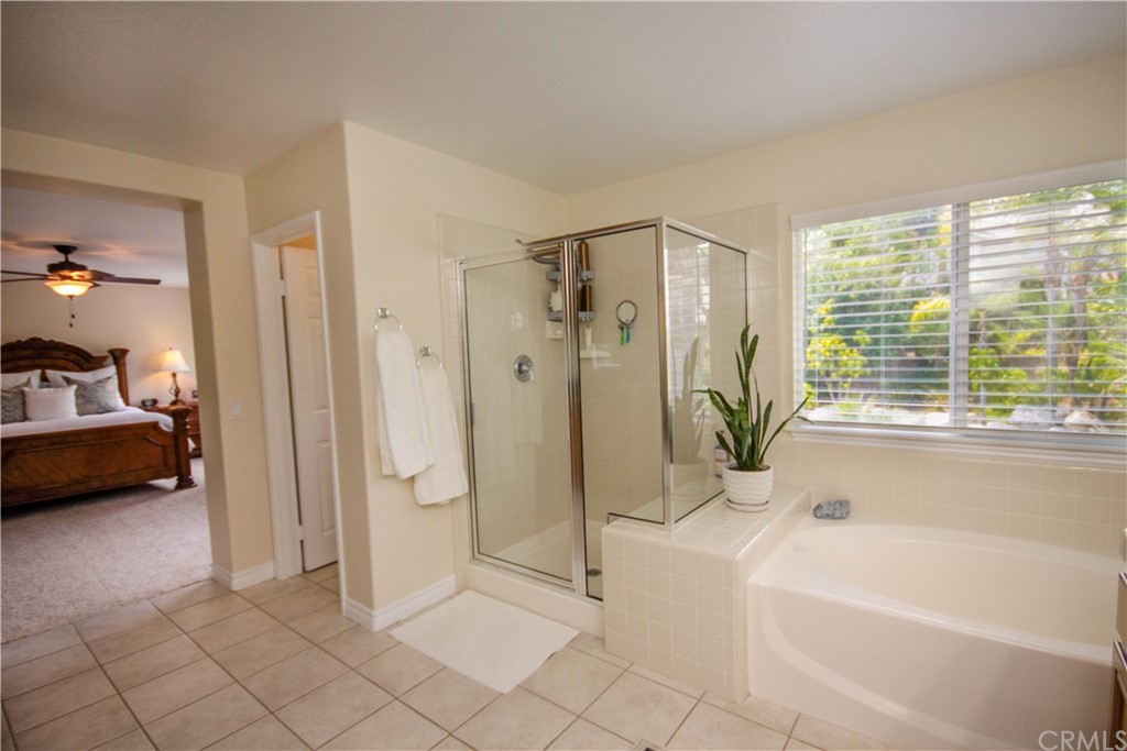 1836 Willow Bluff Drive Corona, CA 92883 - Photo 24 of 64 a bathroom with a tub shower and a sink
