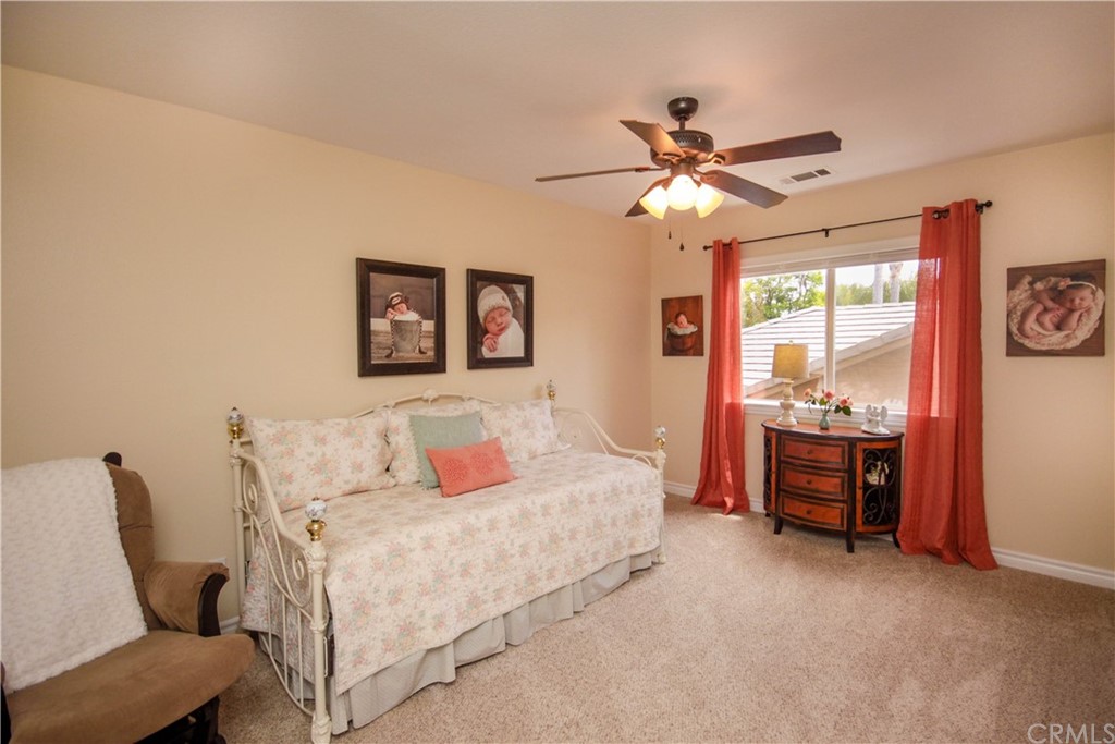 1836 Willow Bluff Drive Corona, CA 92883 - Photo 34 of 64 a bedroom with a bed and a chandelier