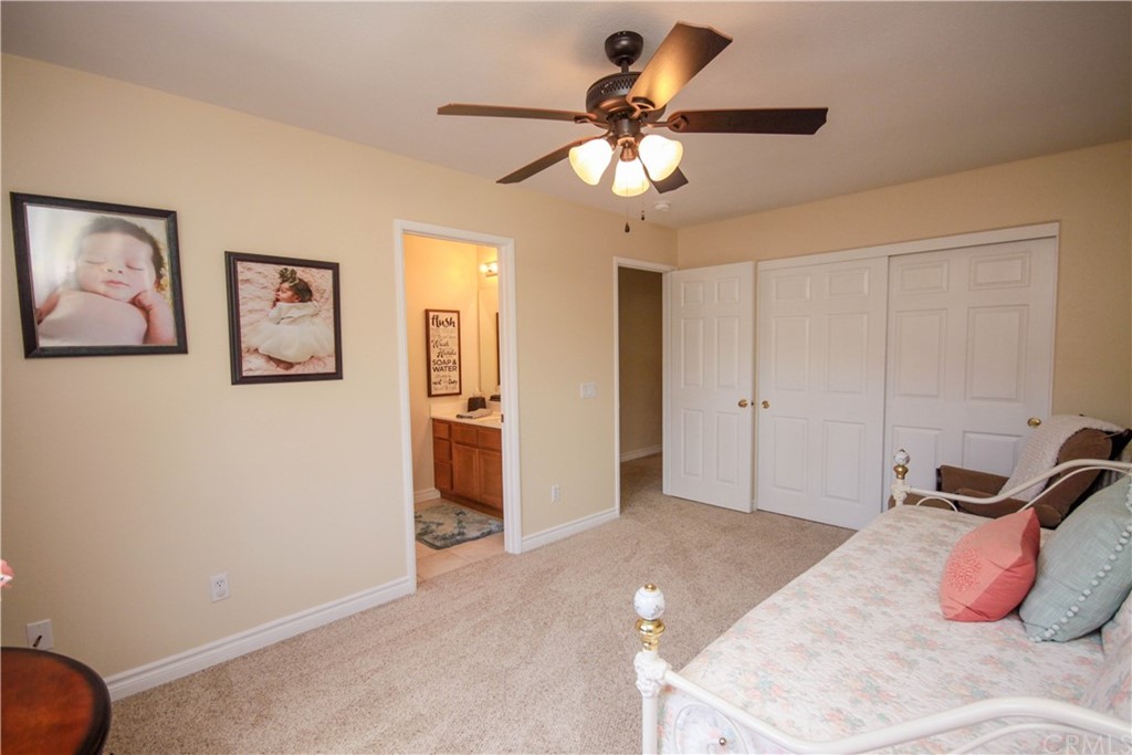 1836 Willow Bluff Drive Corona, CA 92883 - Photo 35 of 64 a bedroom with a bed and a chandelier