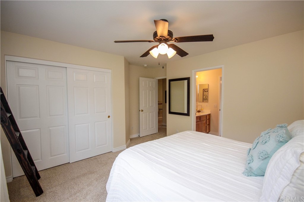 1836 Willow Bluff Drive Corona, CA 92883 - Photo 40 of 64 a bedroom with a bed and a chandelier