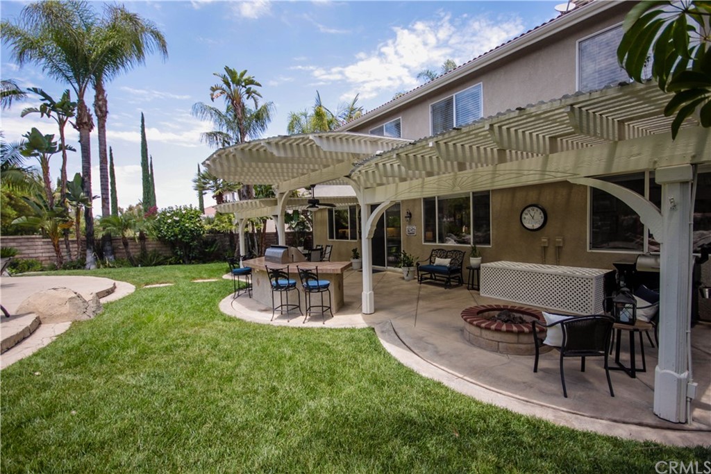 1836 Willow Bluff Drive Corona, CA 92883 - Photo 43 of 64 a view of a patio with table and chairs potted plants and large tree