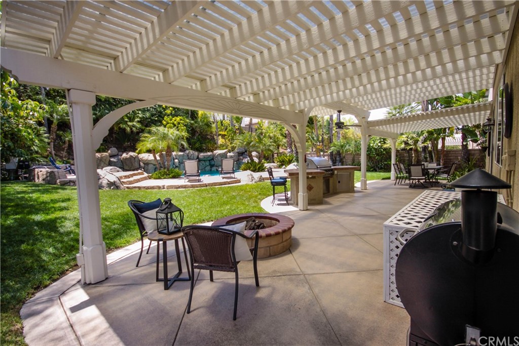 1836 Willow Bluff Drive Corona, CA 92883 - Photo 49 of 64 a patio with a table and chairs and potted plants