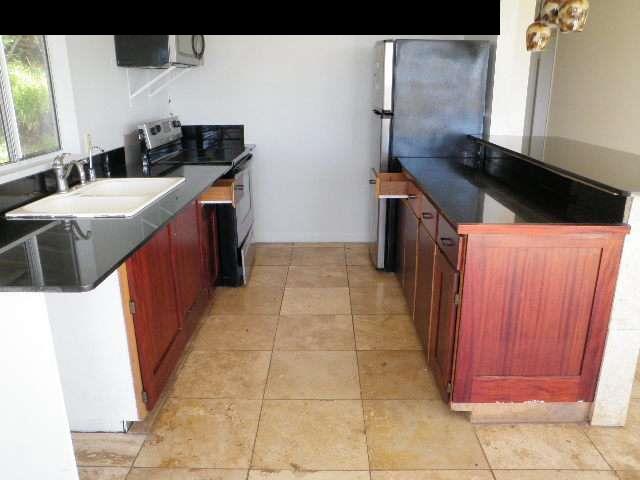 40 Pulehuiki Road Kula, HI 96790 - Photo 2 of 5 a kitchen with stainless steel appliances a stove a sink and a microwave