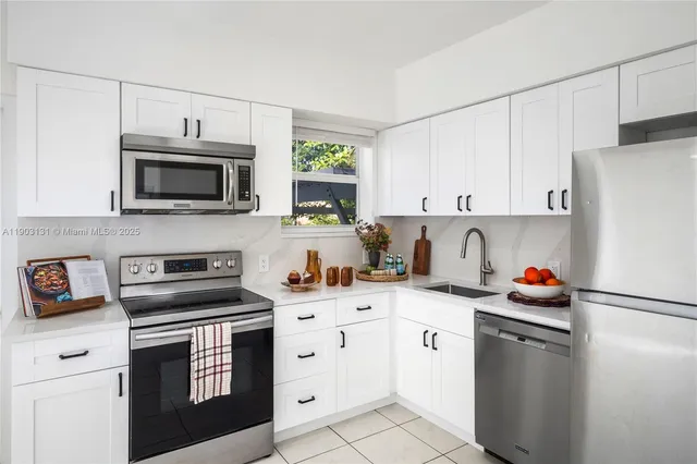 a kitchen with stainless steel appliances a stove microwave and refrigerator