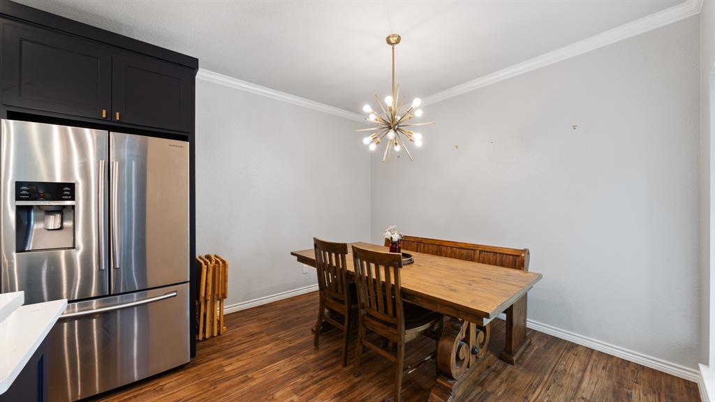 101 Lighthouse Lane Mabank, TX 75143 - Photo 16 of 40 Dining space with ornamental molding, suspended lighting, and dark wood-type flooring