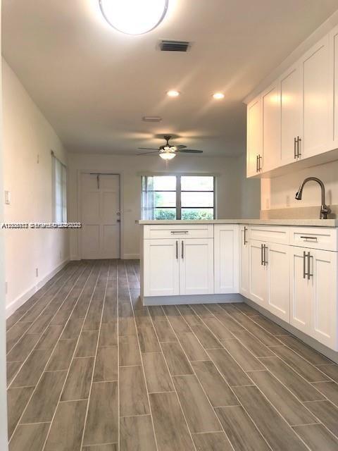 215 Southwest 10th Street Hallandale Beach, FL 33009 - Photo 3 of 14 a view of a kitchen with wooden floor and a sink