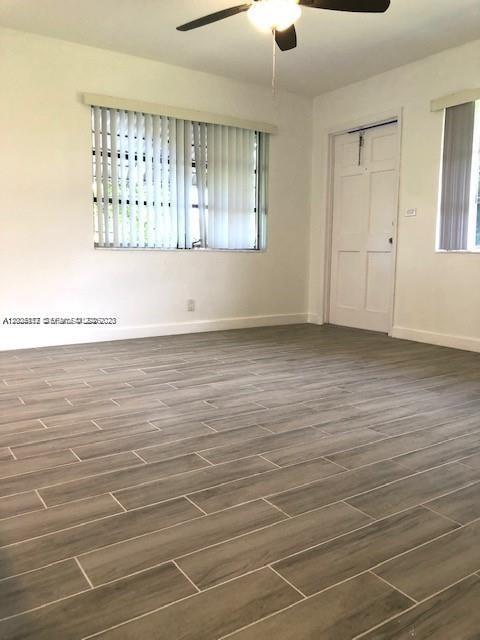 215 Southwest 10th Street Hallandale Beach, FL 33009 - Photo 6 of 14 an empty room with wooden floor and windows