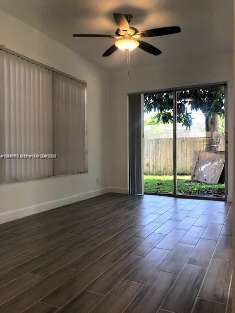 215 Southwest 10th Street Hallandale Beach, FL 33009 - Photo 8 of 14 a view of empty room with wooden floor and fan