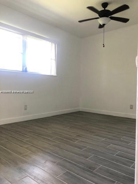 215 Southwest 10th Street Hallandale Beach, FL 33009 - Photo 10 of 14 a view of a room with wooden floor and window