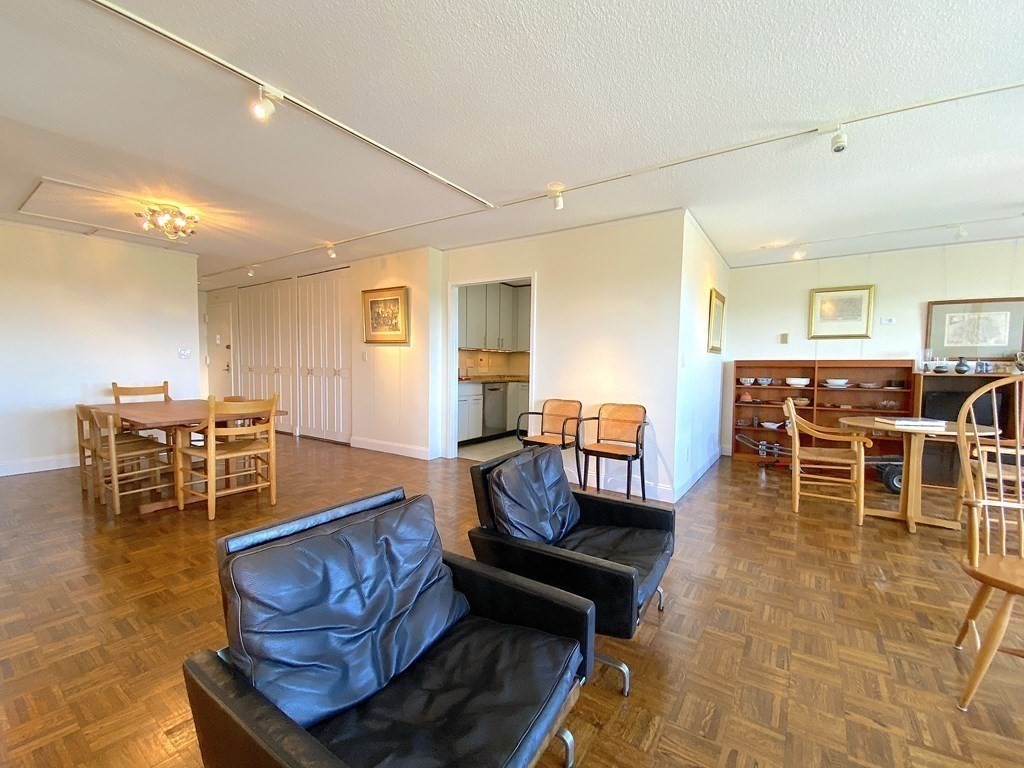 111 Perkins Street, Unit 186 Boston, MA 02130 - Photo 12 of 34 a living room with furniture a dining table and chairs with wooden floor