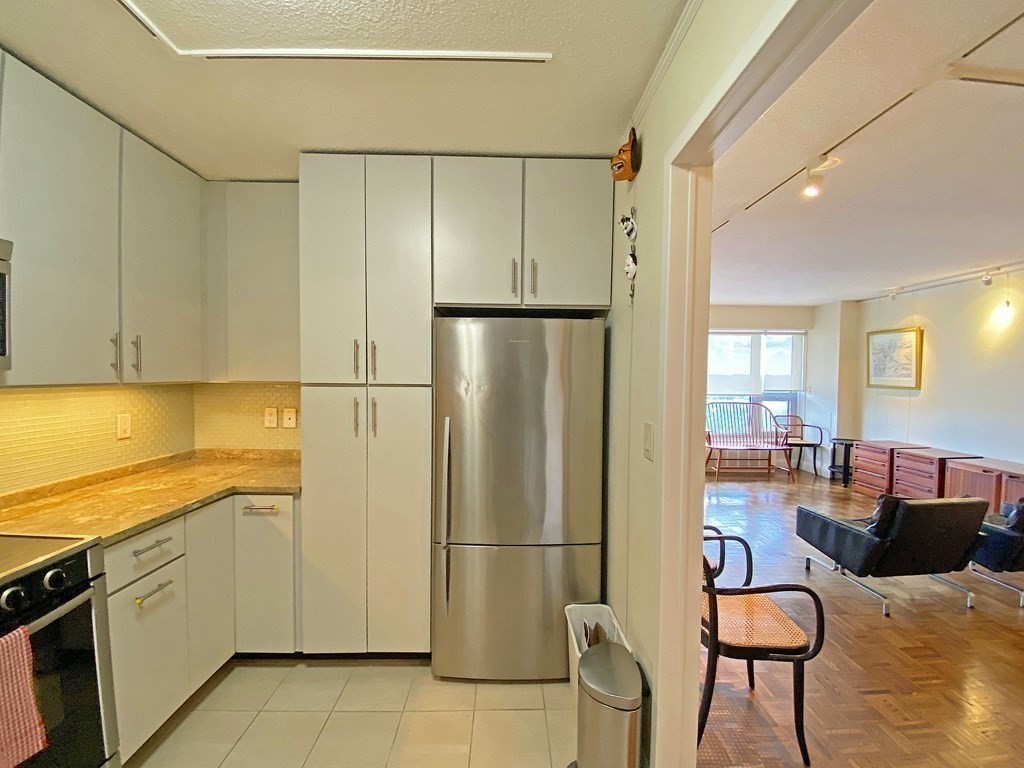111 Perkins Street, Unit 186 Boston, MA 02130 - Photo 16 of 34 a kitchen with stainless steel appliances granite countertop a refrigerator and a stove top oven