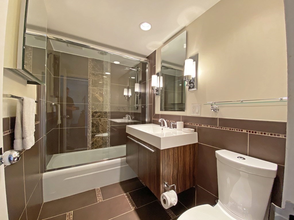 111 Perkins Street, Unit 186 Boston, MA 02130 - Photo 17 of 34 a bathroom with a sink a toilet a mirror and shower