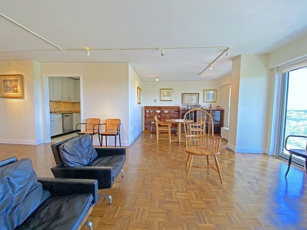 111 Perkins Street, Unit 186 Boston, MA 02130 - Photo 3 of 34 a living room with furniture and a dining table with wooden floor