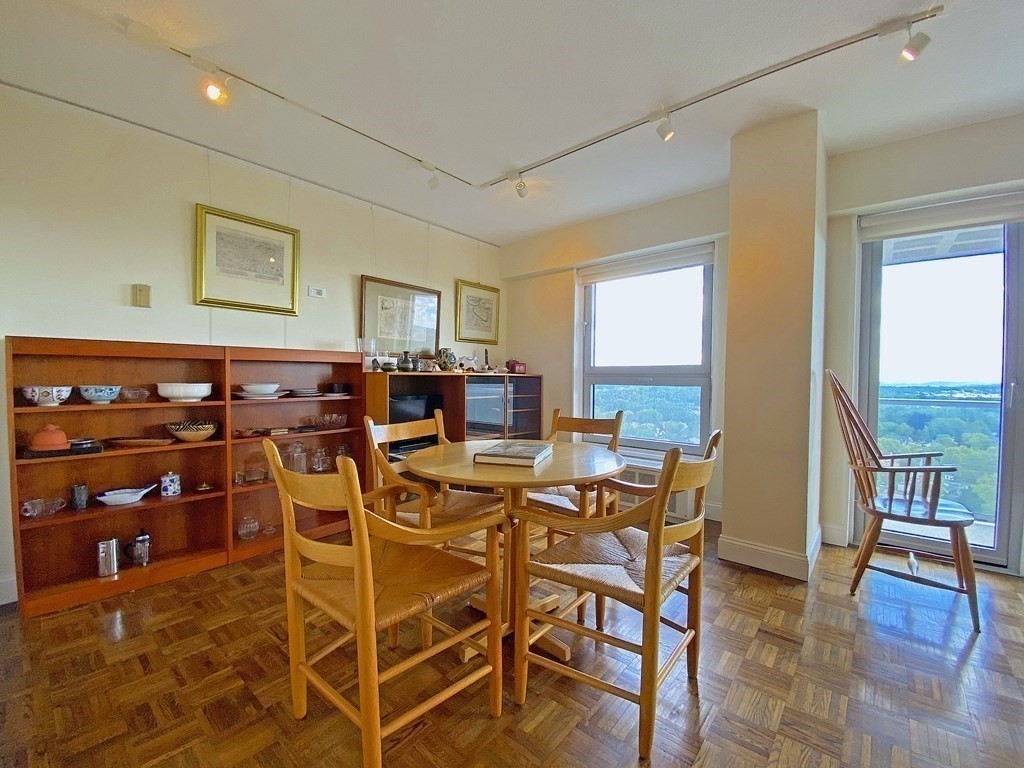 111 Perkins Street, Unit 186 Boston, MA 02130 - Photo 5 of 34 a view of a dining room with furniture and wooden floor