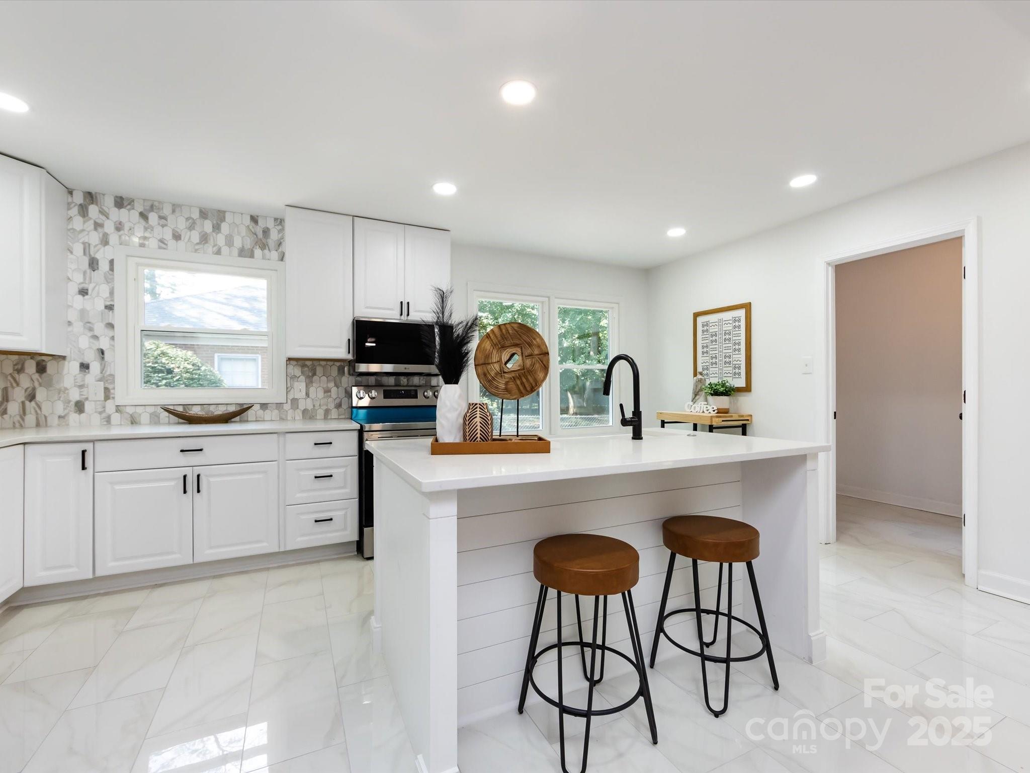 6017 Brace Road Charlotte, NC 28211 - Photo 19 of 47 a kitchen with stainless steel appliances granite countertop a sink a stove a refrigerator cabinets and chairs