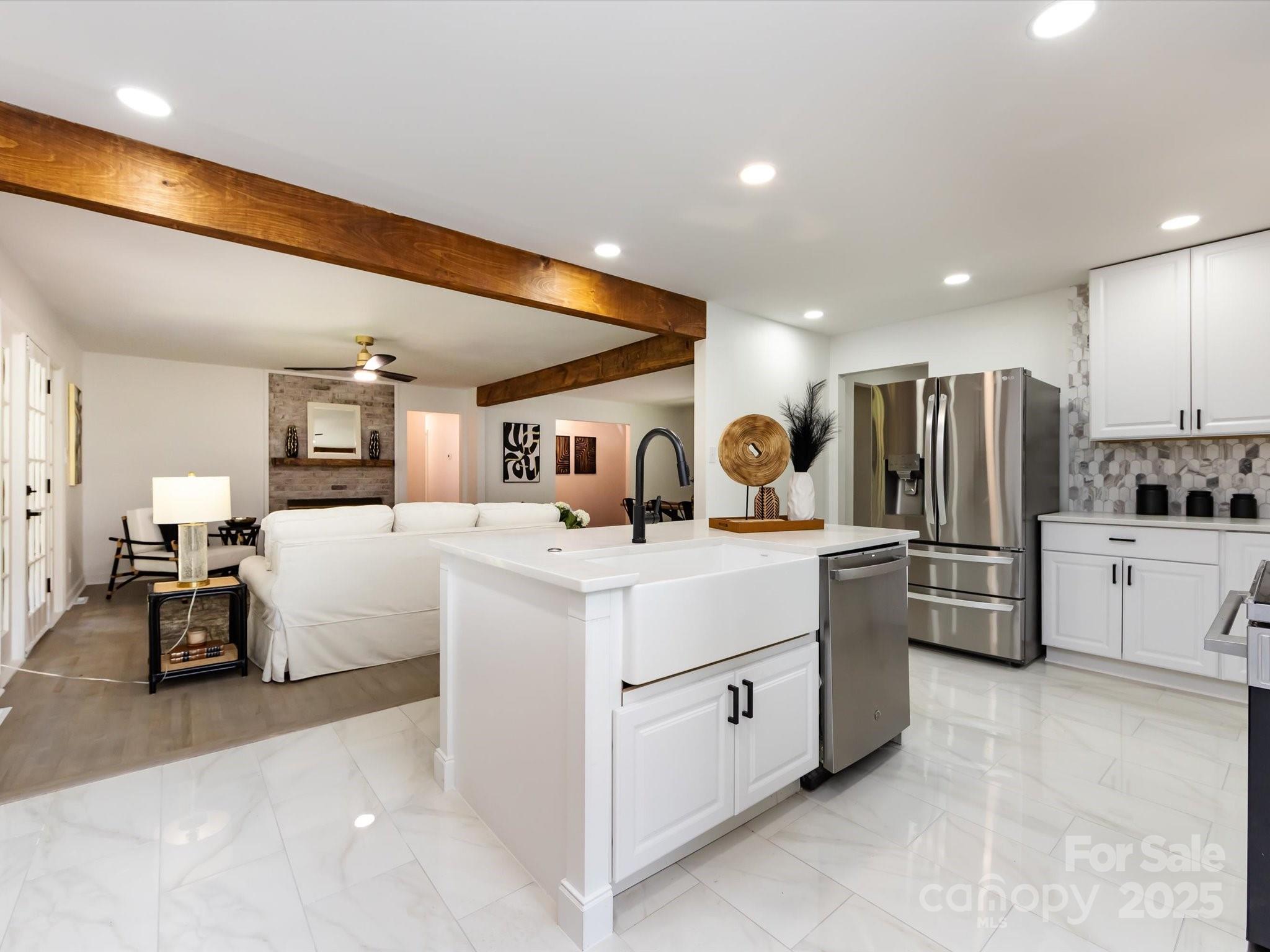 6017 Brace Road Charlotte, NC 28211 - Photo 20 of 47 a large white kitchen with cabinets a sink and appliances