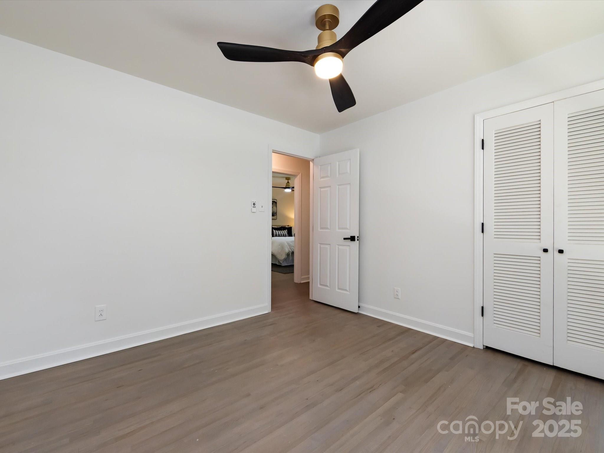 6017 Brace Road Charlotte, NC 28211 - Photo 34 of 47 an empty room with wooden floor closet and windows