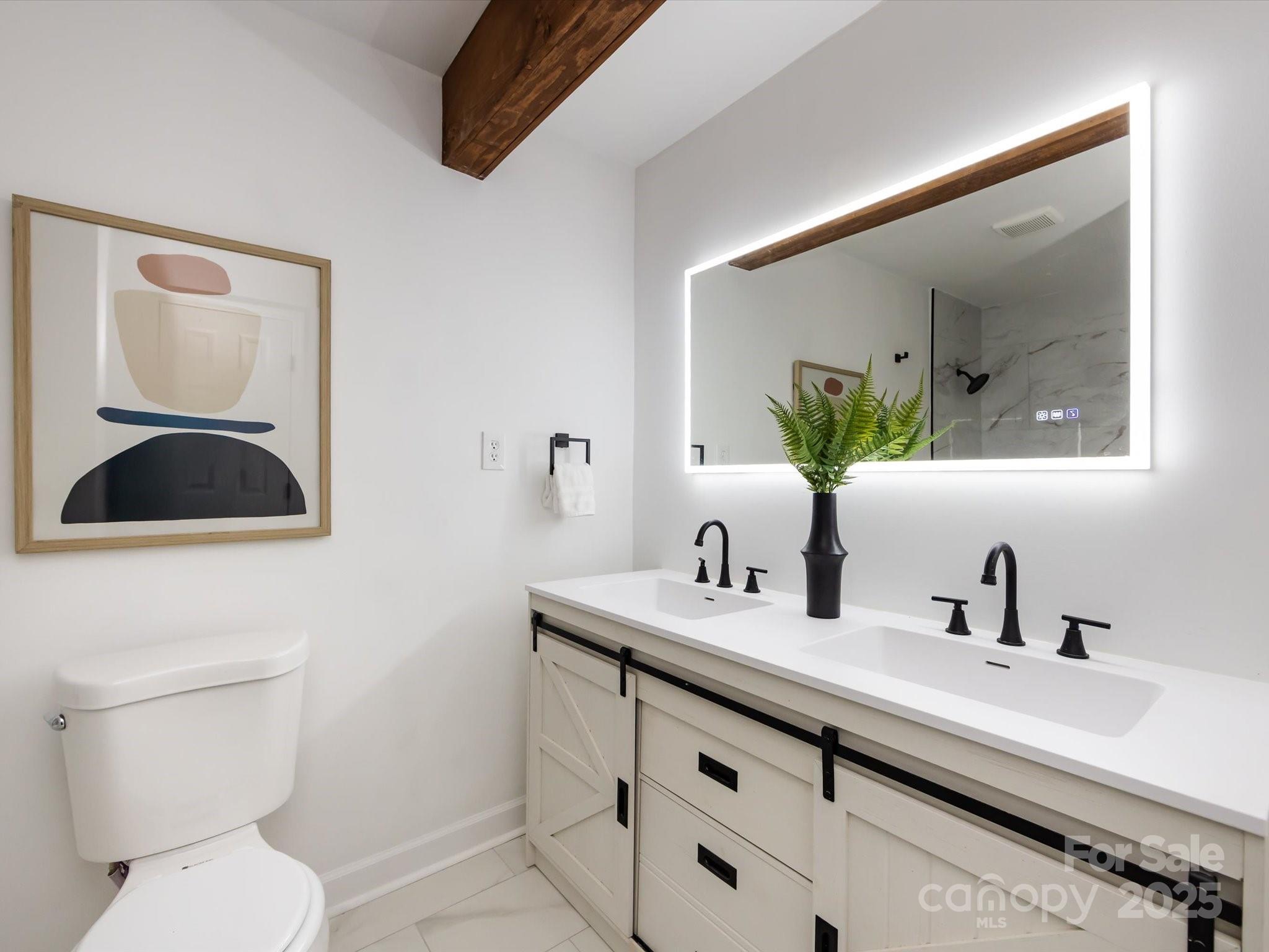 6017 Brace Road Charlotte, NC 28211 - Photo 35 of 47 a bathroom with a toilet sink and mirror