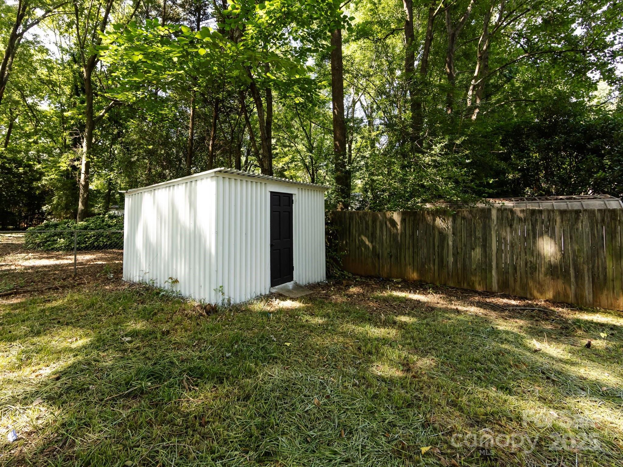 6017 Brace Road Charlotte, NC 28211 - Photo 41 of 47 a backyard of a house with lots of green space and fountain