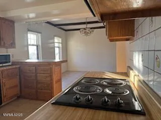a view of an empty room with a fireplace and a window