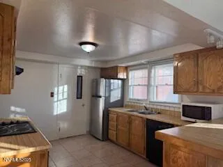 a kitchen with stainless steel appliances wooden cabinets a sink and a stove