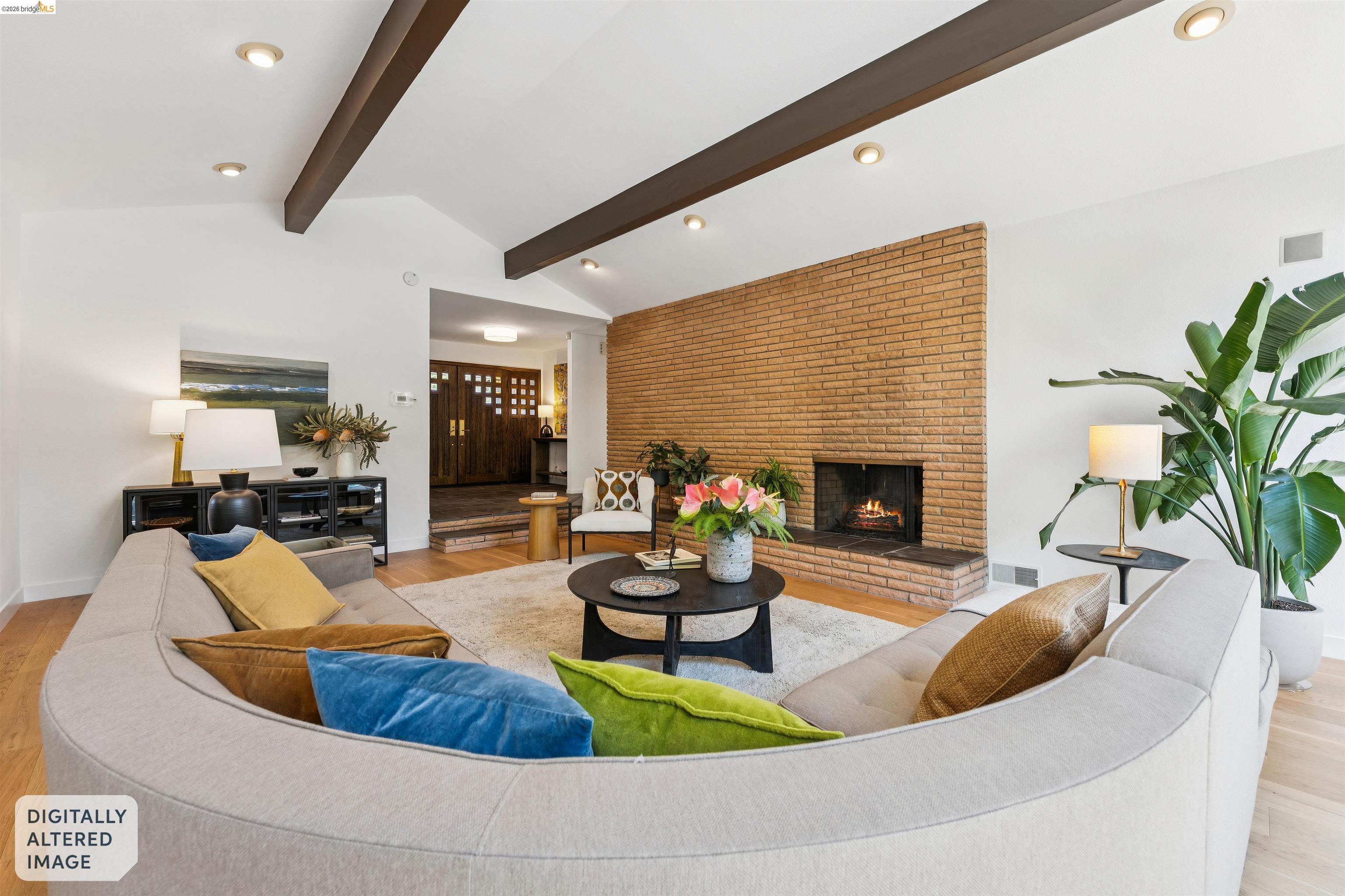7 Jo Lin Court El Sobrante, CA 94803 - Photo 31 of 99 Vaulted ceilings with exposed wood beams define this living area, featuring a brick-clad fireplace with a raised hearth
