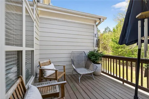 a view of balcony with wooden floor and outdoor seating