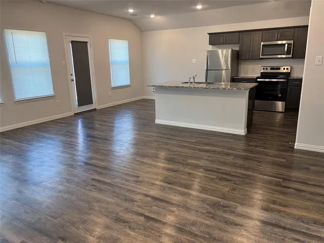 a kitchen with stainless steel appliances a refrigerator and a sink