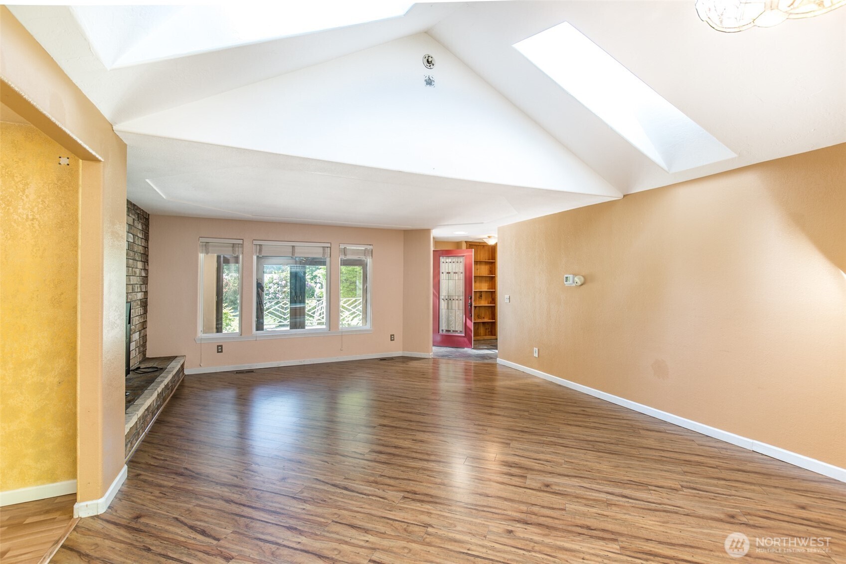 123 Forest Ridge Drive Sequim, WA 98382 - Photo 14 of 32 a view of an empty room with wooden floor and a window
