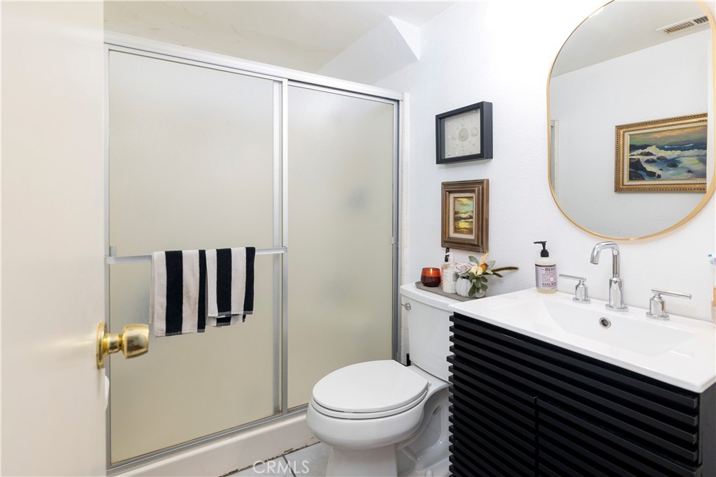 44882 Tehachapi Pass Temecula, CA 92592 - Photo 16 of 34 a bathroom with a toilet a sink and mirror