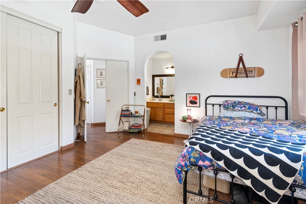 44882 Tehachapi Pass Temecula, CA 92592 - Photo 20 of 34 a bedroom with a bed and wooden floor