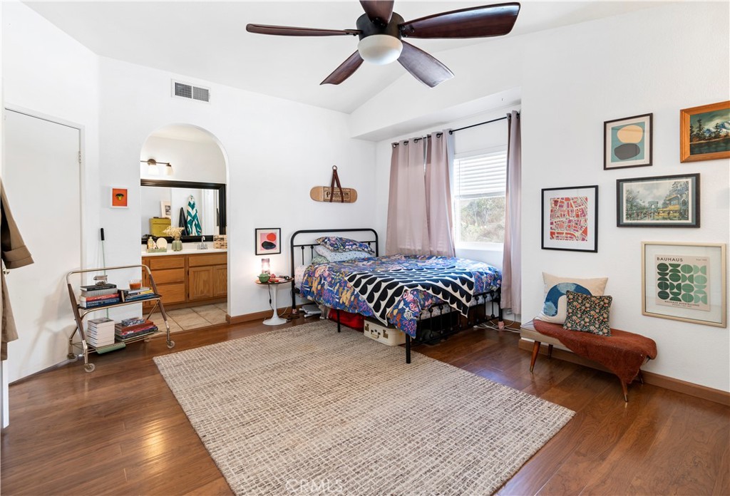 44882 Tehachapi Pass Temecula, CA 92592 - Photo 21 of 34 a bedroom with a bed and wooden floor