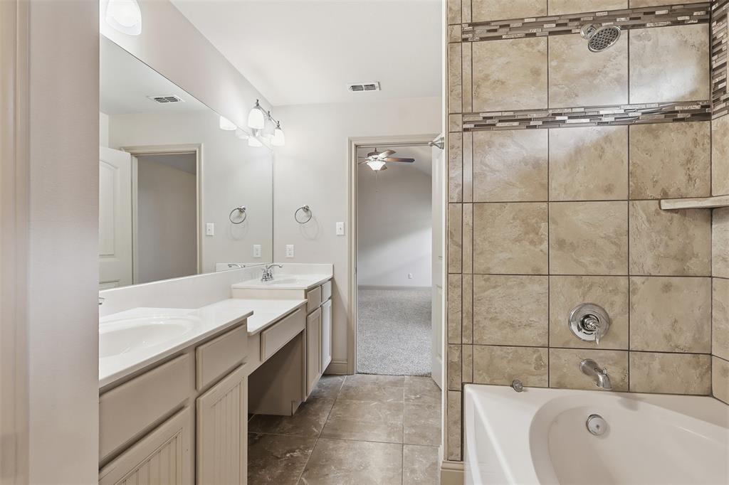 2512 Guinn Farms Road Tyler, TX 75707 - Photo 25 of 29 a bathroom with a tub sink and mirror