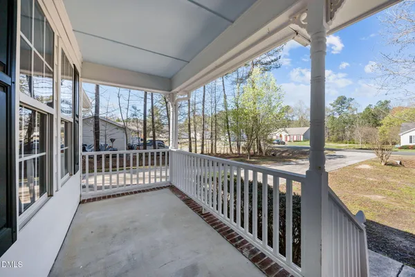a view of a house with a small yard and wooden floor and fence